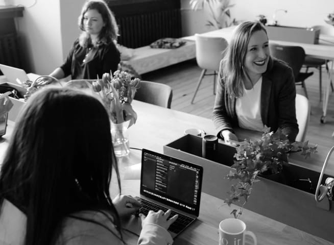 Three women discussing about businesss work